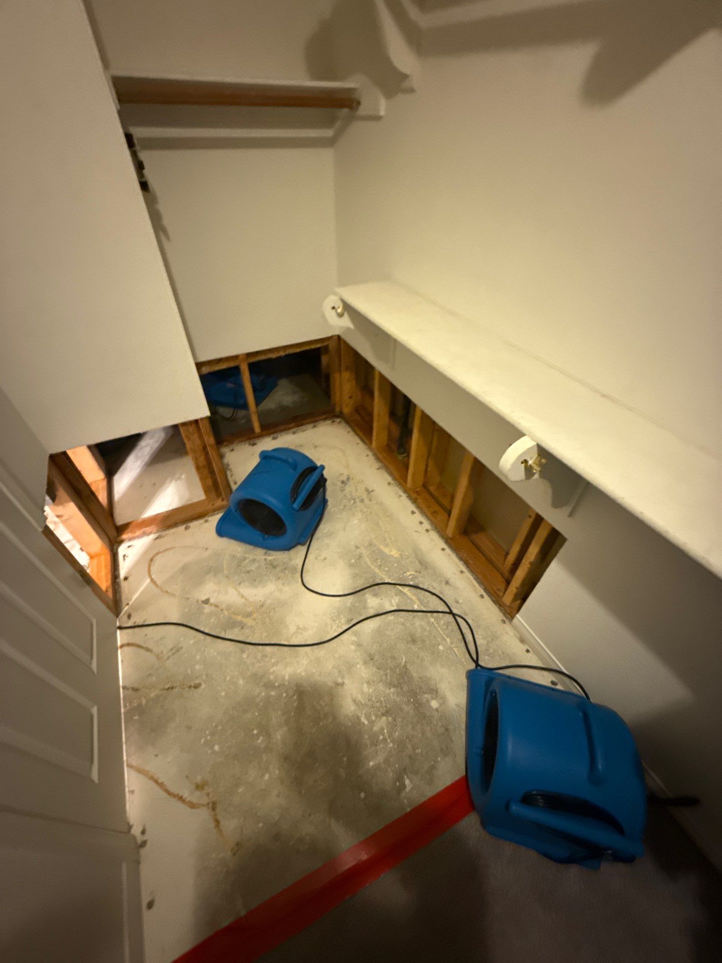 Closet moisture detail work during water damage mitigation